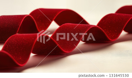 Luxurious Red Velvet Ribbon Flowing Elegantly for a Festive Christmas Celebration Background 131645530