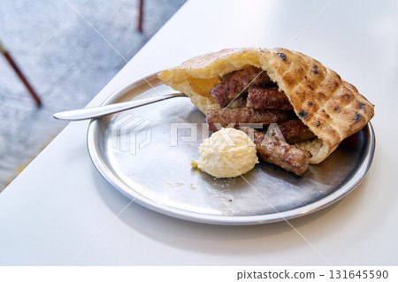 Sarajevo-style cevapi aka Sarajevski cevapi a national dish of Bosnia and Herzegovina 131645590