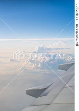 Sea of clouds and blue sky outside the airplane window 131645636
