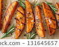 Grilled sweet potato wedges with rosemary, coarse salt, and pepper. Perfect for healthy eating, Thanksgiving sides, or autumn recipes 131645657