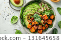 Healthy vegan bowl with avocado, quinoa, roasted sweet potato, spinach, and sesame seeds. Perfect for clean eating, lunch ideas, or plant-based diet inspiration 131645658
