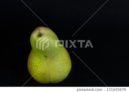 Single Green and Red Corella Pear Isolated on Black. Natural Sweet Snack. Single Green and Red Corella Pear Isolated on Black. Natural Sweet Snack. 131645679