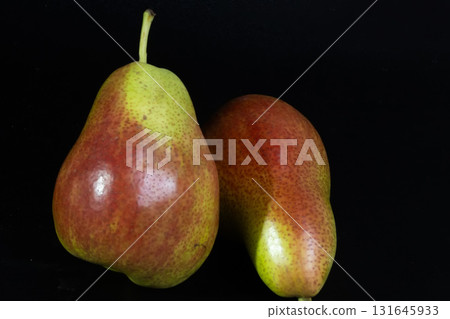 Colorful Forelle pears pop against a dark backdrop, highlighting their unique speckled skin and fresh appeal. Colorful Forelle pears pop against a dark backdrop, highlighting their unique speckled skin and fresh appeal. 131645933
