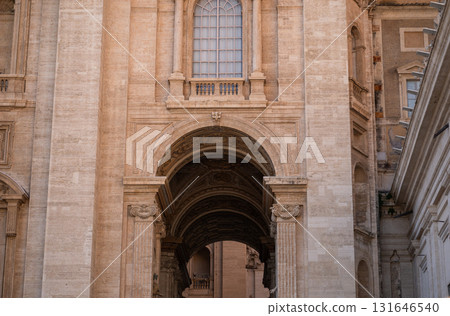 Historic stone arch and ornate architectural details of ancient European building facade Historic stone arch and ornate architectural details of ancient European building facade 131646540