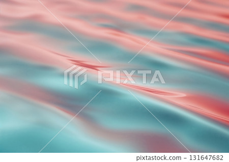 Smooth turquoise and coral ripples blend seamlessly across calming gradient surface 131647682