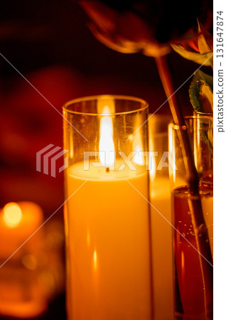 Row of warm yellow LED candles in candle holders for event decor in the dark 131647874