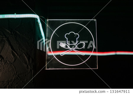 Square neon sign with chef logo, fork, spoon and hat on black background Square neon sign with chef logo, fork, spoon and hat on black background 131647911