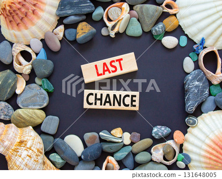Last chance symbol. Concept word Last chance on beautiful wooden blocks. Beautiful black paper background. Beautiful sea stones and sea shells. Business last chance concept. Copy space. Last chance symbol. Concept word Last chance on beautiful wooden blocks. Beautiful black paper background. Beautiful sea stones and sea shells. Business last chance concept. Copy space. 131648005