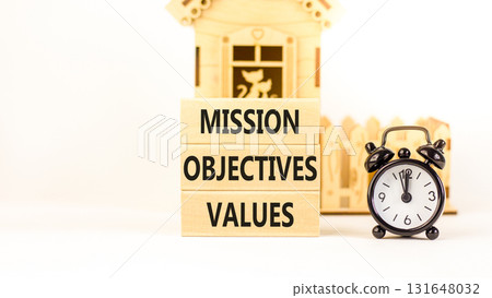 Mission objectives values symbol. Concept words Mission Objectives Values on beautiful blocks. Beautiful white background. Black alarm clock. Business mission objectives values concept. Copy space. 131648032
