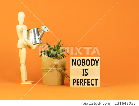 Nobody is perfect symbol. Concept words Nobody is perfect on beautiful wooden block. Beautiful orange background. Business motivational lifestyle and nobody is perfect concept. Copy space. 131648033