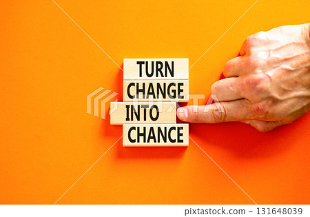 Turn change into chance symbol. Concept words phrase Turn change into chance on beautiful wooden blocks. Beautiful orange paper background. Business Turn change into chance concept. Copy space. 131648039