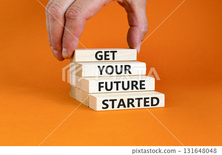 Get your future started symbol. Concept words Get your future started on beautiful wooden blocks. Beautiful orange table orange background. Business get your future started concept. Copy space. Get your future started symbol. Concept words Get your future started on beautiful wooden blocks. Beautiful orange table orange background. Business get your future started concept. Copy space. 131648048