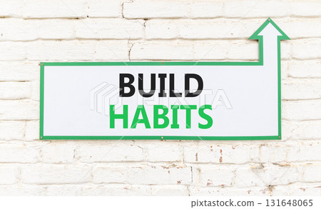 Build habits symbol. Concept word Build habits on beautiful white sign on white brick wall. Beautiful white brick wall background. Business build habits concept. Copy space. 131648065