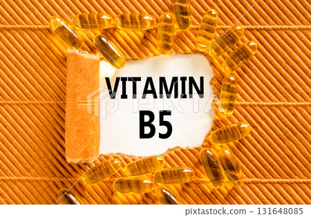 Vitamin B5 pantothenic acid symbol. Concept words Vitamin B5 on beautiful white paper. Yellow pills tablets. Beautiful brown background. Medical healthy lifestyle Vitamin B5 concept. Vitamin B5 pantothenic acid symbol. Concept words Vitamin B5 on beautiful white paper. Yellow pills tablets. Beautiful brown background. Medical healthy lifestyle Vitamin B5 concept. 131648085