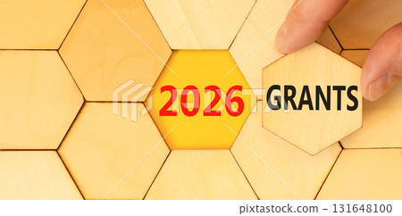 2026 Grants symbol. Concept words 2026 Grants on beautiful wooden puzzles. Beautiful wooden puzzles background. Businessman's hand. Business and 2026 grants concept. Copy space. 131648100