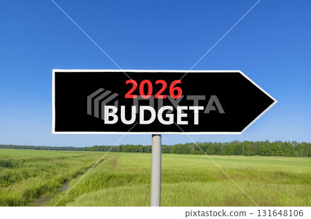 2026 Budget symbol. Concept words 2026 Budget on beautiful black road sign. Beautiful green grass field forest and blue sky background. Business and 2026 budget concept. Copy space. 2026 Budget symbol. Concept words 2026 Budget on beautiful black road sign. Beautiful green grass field forest and blue sky background. Business and 2026 budget concept. Copy space. 131648106
