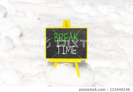 Break time symbol. Concept word Break time on beautiful black blackboard. Beautiful white snow background. White snow. Black blackboard. Business break time concept. Copy space. 131648146