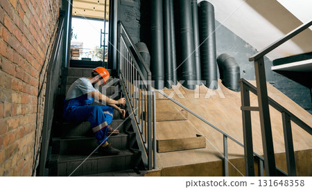 Engineer resting on stairs after technical inspection work 131648358