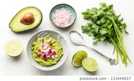 Fresh Guacamole Ingredients and Preparation on White Marble Surface avocado lime Fresh Guacamole Ingredients and Preparation on White Marble Surface avocado lime 131648837