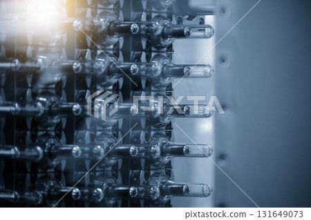 Close up scene of injection process group of preform shape of PET bottle products in the blue scene Close up scene of injection process group of preform shape of PET bottle products in the blue scene 131649073