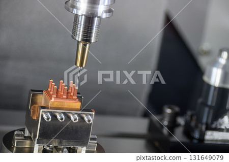 Close up scene the CNC milling machine cutting the copper electrode parts. 131649079
