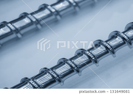 Close up scene body of the barrel screw of injection machine spare parts in the light blue scene. 131649081