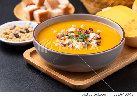 Butternut squash pumpkin soup with granola, Homemade food in autumn season Butternut squash pumpkin soup with granola, Homemade food in autumn season 131649345
