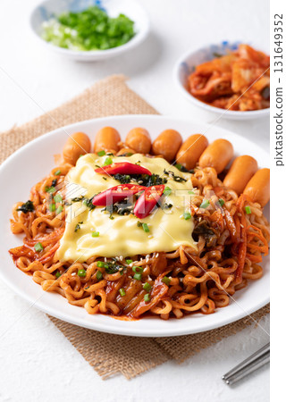 Korean spicy instant noodles with kimchi, sausage and Mozzarella cheese Korean spicy instant noodles with kimchi, sausage and Mozzarella cheese 131649352
