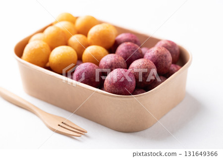 Deep fried sweet potato balls in paper box on white background, Thai street food  131649366
