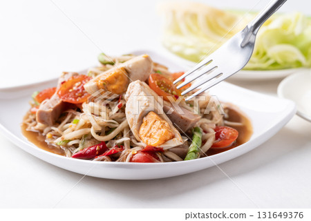 Thai food (Som Tum), Spicy papaya salad with steamed pork sausage and salted egg Thai food (Som Tum), Spicy papaya salad with steamed pork sausage and salted egg 131649376