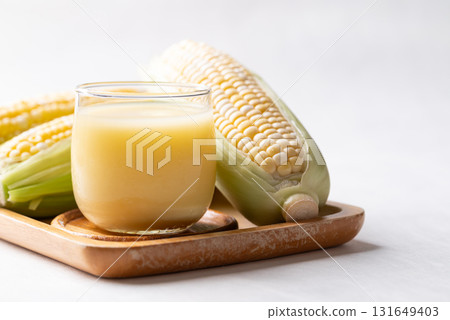Sweetcorn milk in glass and fresh sweetcorn, Alternative milk from plant, dairy free 131649403