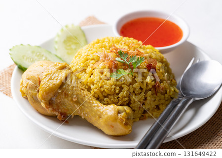 Thai Biryani rice with chicken and chili sauce on white background 131649422