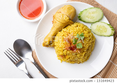 Top view of Thai Biryani rice with chicken and chili sauce on white background Top view of Thai Biryani rice with chicken and chili sauce on white background 131649423
