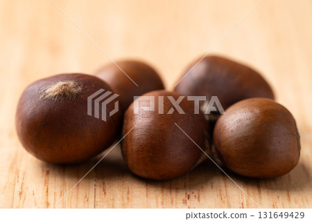 Roasted chestnuts on wooden background, Japanese chestnuts Roasted chestnuts on wooden background, Japanese chestnuts 131649429