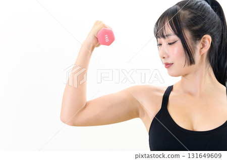 A cool woman working out, holding dumbbells and building biceps, muscle training girl, white background A cool woman working out, holding dumbbells and building biceps, muscle training girl, white background 131649609
