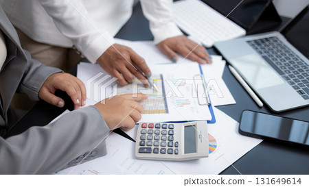 Businesswomen analyzing financial data and charts during meeting in modern office 131649614