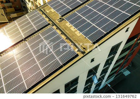 Aerial view of solar photovoltaic panels on a roof top of residential building block for producing clean electric energy. Autonomous housing concept. 131649762