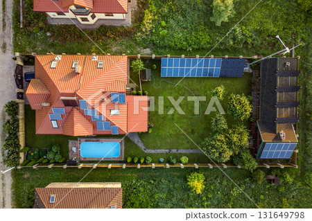 Aerial view of rural residential area with private homes between green fields at sunrise. Aerial view of rural residential area with private homes between green fields at sunrise. 131649798
