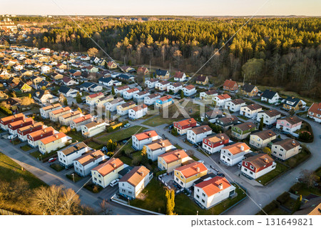 Aerial view of residential houses with red roofs and streets with parked cars in rural town area. Quiet suburbs of a modern european city. Aerial view of residential houses with red roofs and streets with parked cars in rural town area. Quiet suburbs of a modern european city. 131649821
