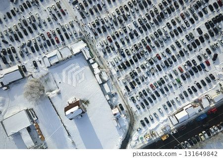 Aerial view of many cars parked for sale and people customers walking on car market or parking lot in winter Aerial view of many cars parked for sale and people customers walking on car market or parking lot in winter 131649842