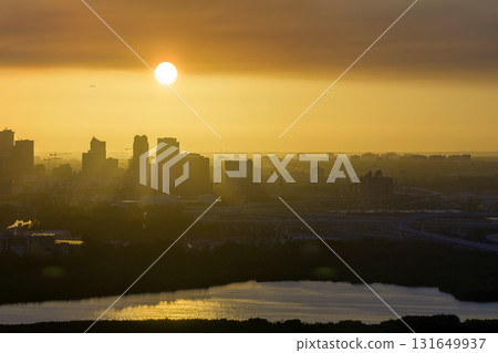 Aerial view of downtown district of Tampa city in Florida, USA at sunset. Dark silhouette of high skyscraper office buildings in modern american midtown Aerial view of downtown district of Tampa city in Florida, USA at sunset. Dark silhouette of high skyscraper office buildings in modern american midtown 131649937