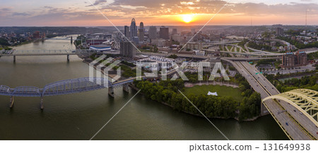 Aerial view of downtown district highway traffic in Cincinnati city, Ohio at sunset. Brightly illuminated high skyscraper buildings in modern American midtown 131649938