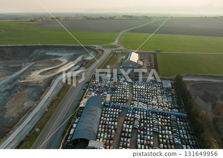 Aerial view of big parking lot of junkyard with rows of discarded broken cars. Recycling of old vehicles 131649956