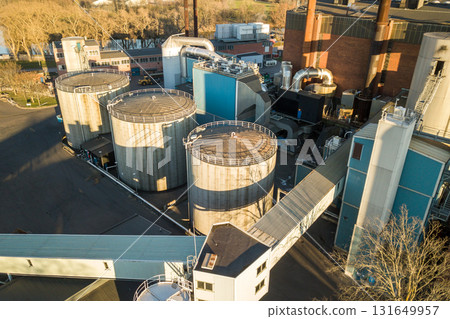 Aerial view of big fuel reservoirs in petroleum industrial zone and metal exhaust pipes of oil refinery factory. 131649957