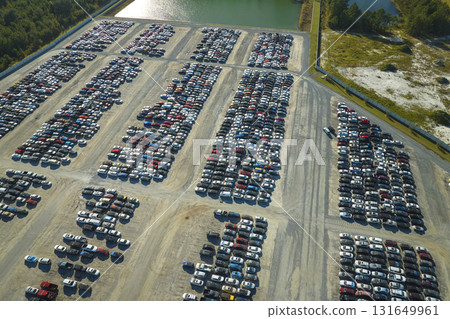 Aerial view of auction reseller company big parking lot with parked cars ready for remarketing services. Sales of secondhand vehicles Aerial view of auction reseller company big parking lot with parked cars ready for remarketing services. Sales of secondhand vehicles 131649961