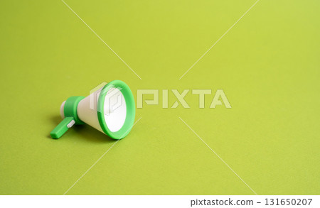 A green megaphone with a background and space for text. Concept of ecology and green technologies. Call for action and announcements. Promotions and news. Environmental awareness, eco campaigns 131650207