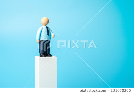 An office worker on a pedestal. Business presentation, space for text. Advertising, invitations to business events. Jobs, hiring, and recruiting. Leadership, recognition in career, corporate image. An office worker on a pedestal. Business presentation, space for text. Advertising, invitations to business events. Jobs, hiring, and recruiting. Leadership, recognition in career, corporate image. 131650260