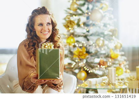 Smiling Woman with Festive Green Gift Box Smiling Woman with Festive Green Gift Box 131651419