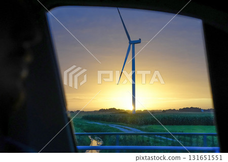 Wind tower turbine power plant at sunset 131651551