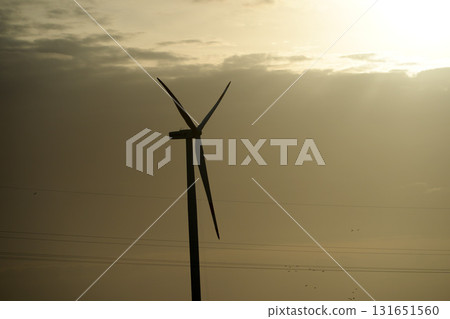 Wind tower turbine power plant at sunset Wind tower turbine power plant at sunset 131651560